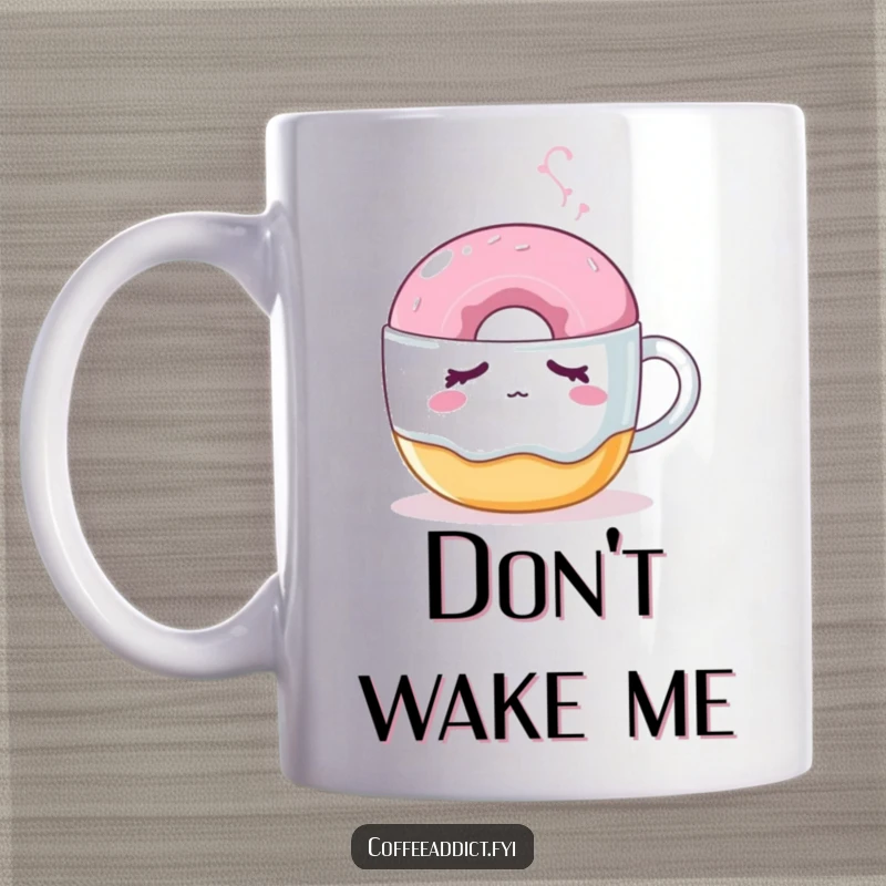Funny mug featuring a sleepy donut being nudged by a steaming coffee mug, capturing a cute morning scene.