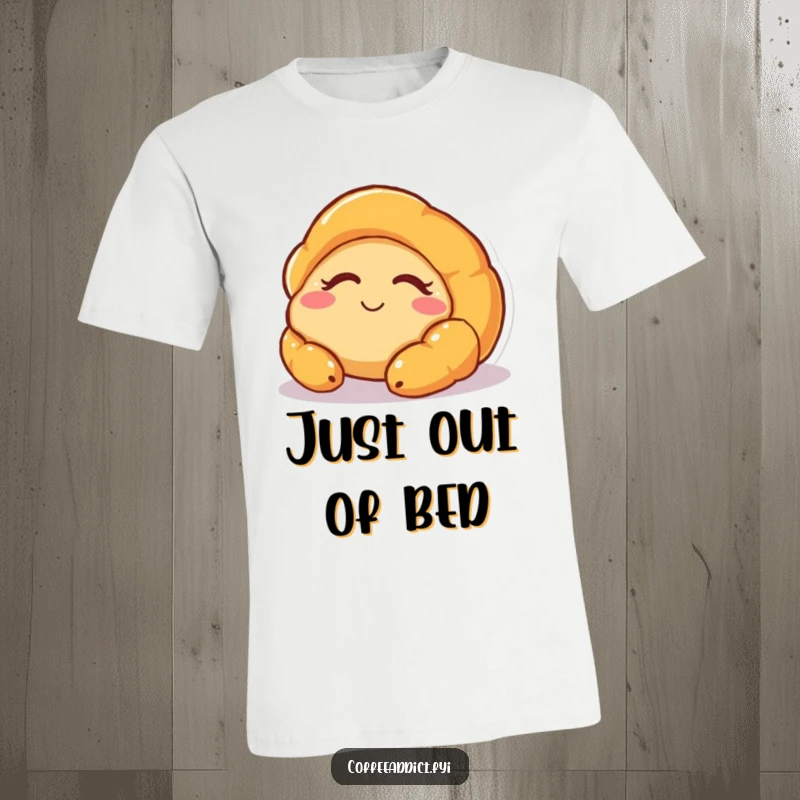 Funny t-shirt featuring a sleepy croissant character stretching and smiling as it wakes up, perfect for relaxed days.